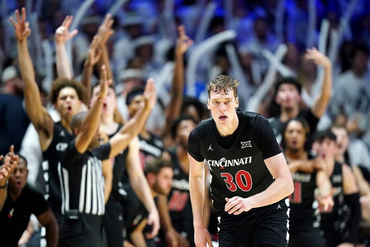 The Cincinnati Bearcats bench reacts to a made 3-point basket by Cincinnati Bearcats forward Viktor Lakhin (30) in the first half of the 91st Crosstown Shootout basketball game between the Cincinnati Bearcats and the Xavier Musketeers, Saturday, Dec. 9, 2023, at Cintas Center in Cincinnati. The Xavier Musketeers won, 84-79.