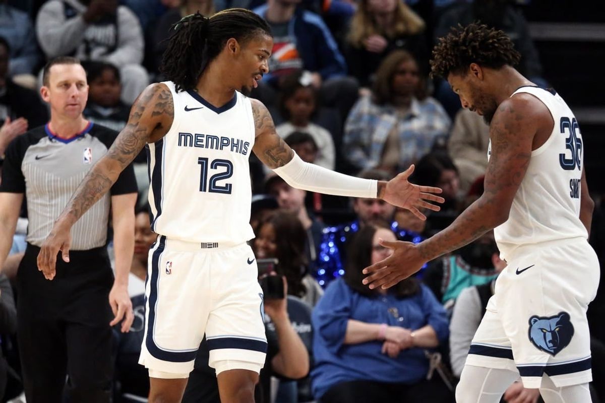 Dec 31, 2023; Memphis, Tennessee, USA; Memphis Grizzlies guard Ja Morant (12) reacts with guard Marcus Smart (36) during the second half against the Sacramento Kings at FedExForum.