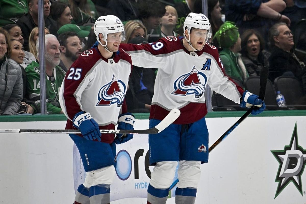 Jan 4, 2024; Dallas, Texas, USA; Colorado Avalanche right wing Logan O'Connor (25) and center Nathan MacKinnon (29) celebrates the game winning goal scored by MacKinnon during the overtime period against the Dallas Stars at the American Airlines Center.