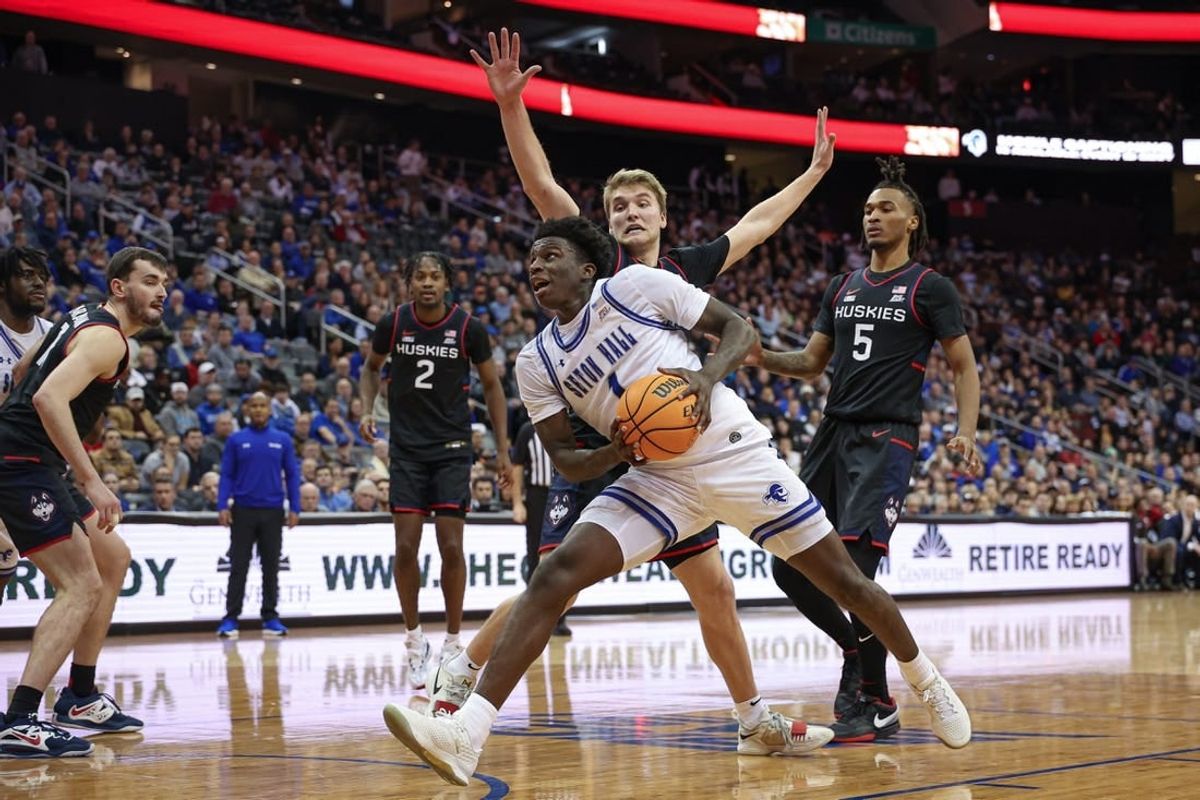 Dec 20, 2023; Newark, New Jersey, USA; Seton Hall Pirates guard Kadary Richmond (1) drives to the basket in front of Connecticut Huskies guard Cam Spencer (12) and guard Stephon Castle (5) during the second half at Prudential Center.