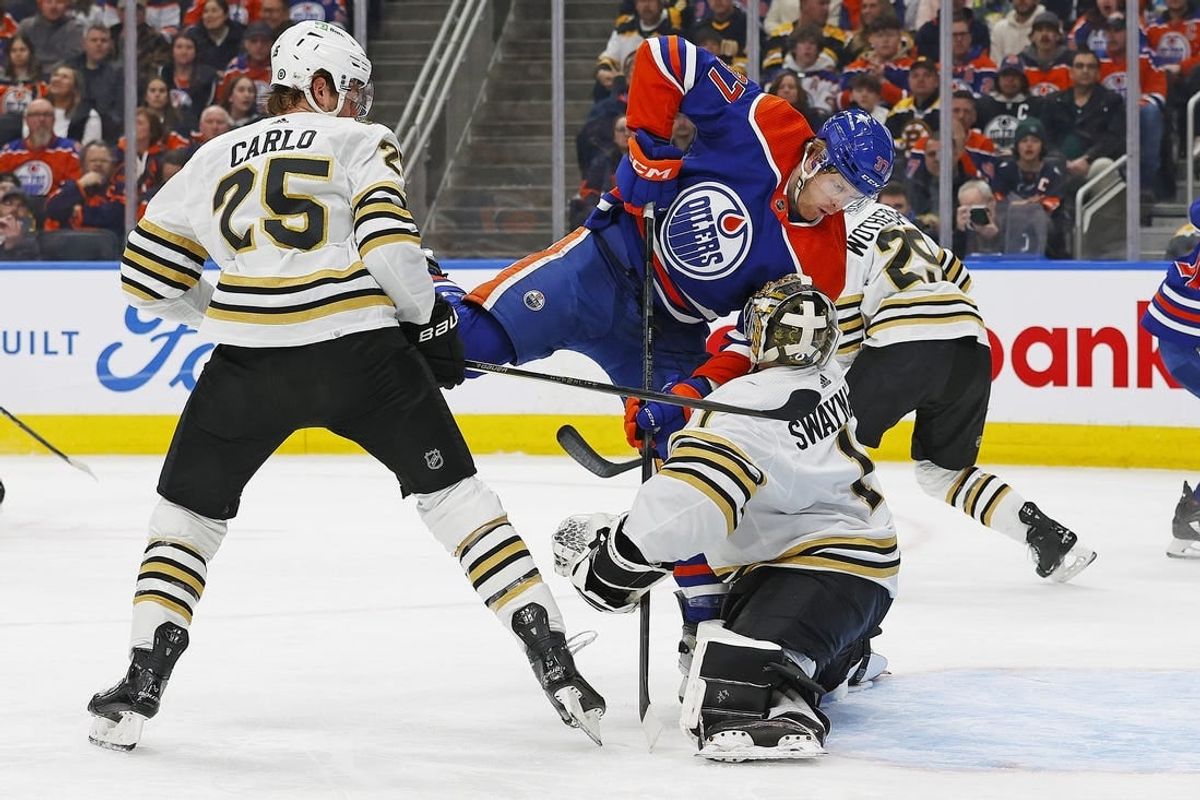 Feb 21, 2024; Edmonton, Alberta, CAN; Edmonton Oilers forward Warren Foegele (37) crashes into Boston Bruins goaltender Jeremy Swayman (1) during the first period at Rogers Place.