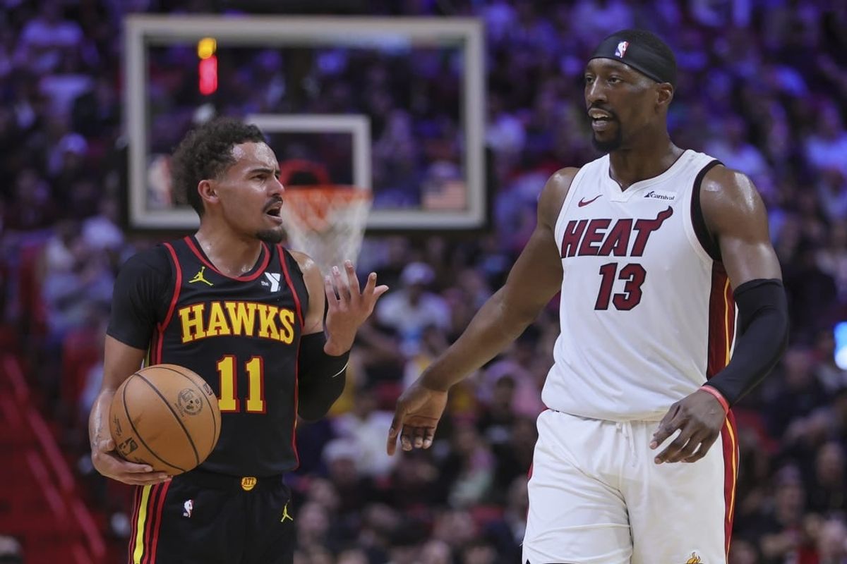 Dec 22, 2023; Miami, Florida, USA; Atlanta Hawks guard Trae Young (11) and Miami Heat center Bam Adebayo (13) talk during the second quarter at Kaseya Center.