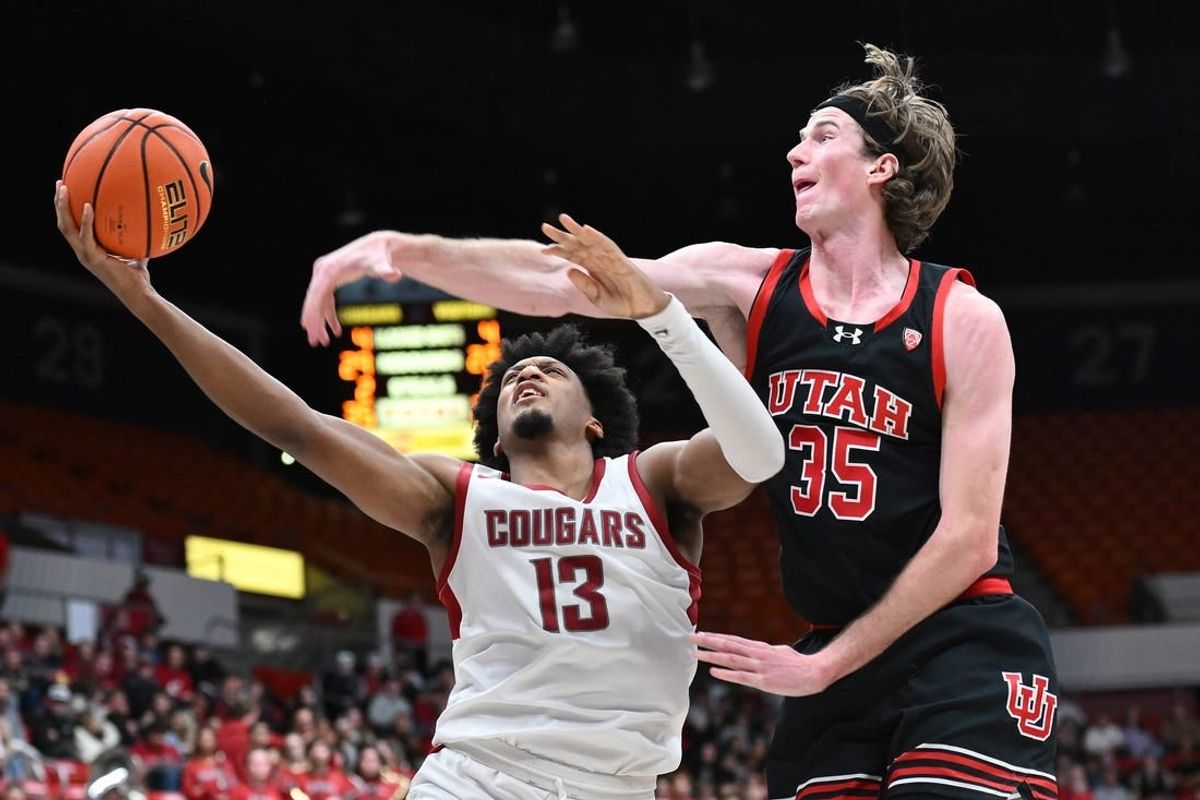 Jan 24, 2024; Pullman, Washington, USA; Washington State Cougars forward Isaac Jones (13) shoots the ball against Utah Utes center Branden Carlson (35) in the second half at Friel Court at Beasley Coliseum. Washington State won 79-57.
