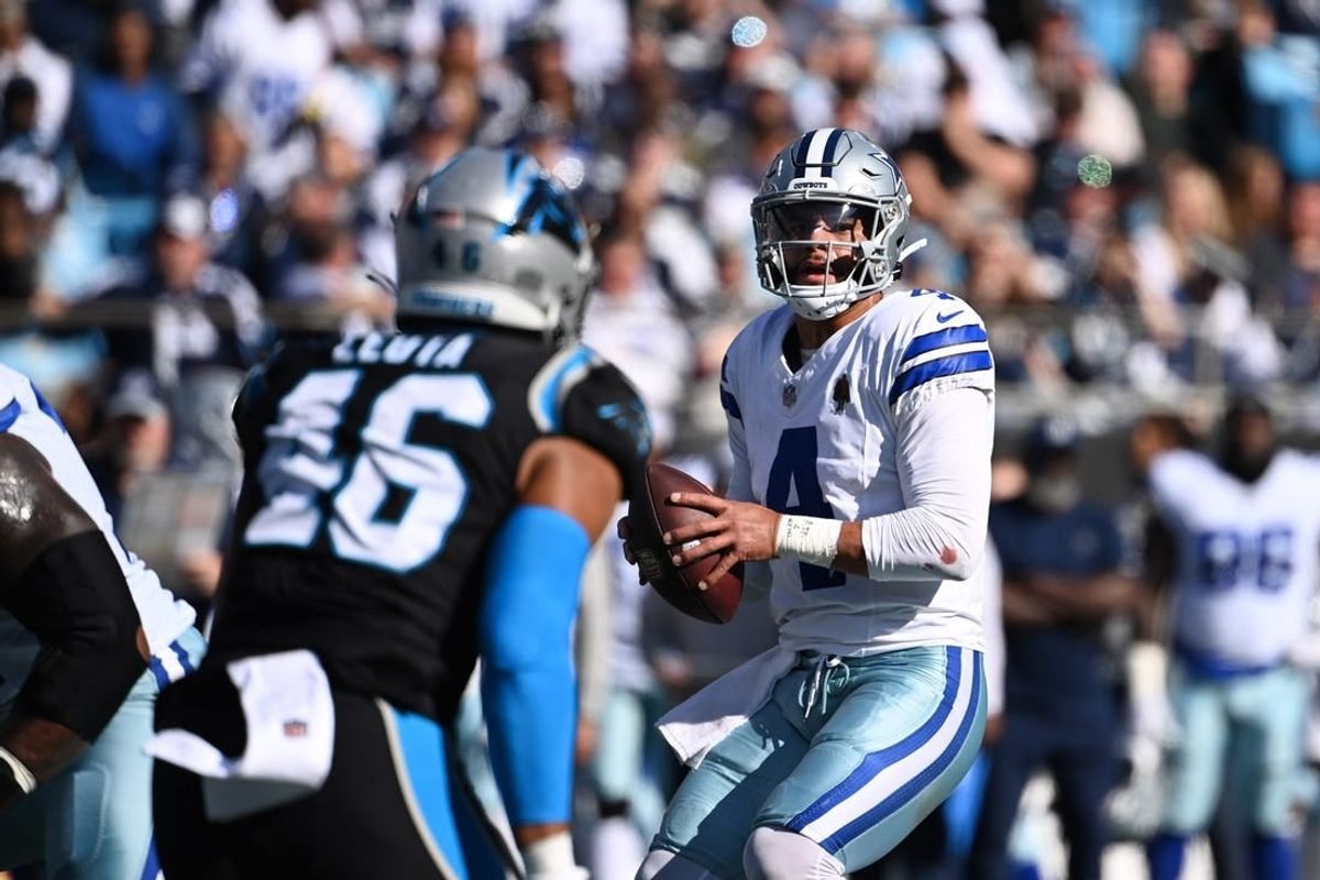 Nov 19, 2023; Charlotte, North Carolina, USA;  Dallas Cowboys quarterback Dak Prescott (4) looks to pass as Carolina Panthers linebacker Eku Leota (46) defends in the second quarter at Bank of America Stadium.