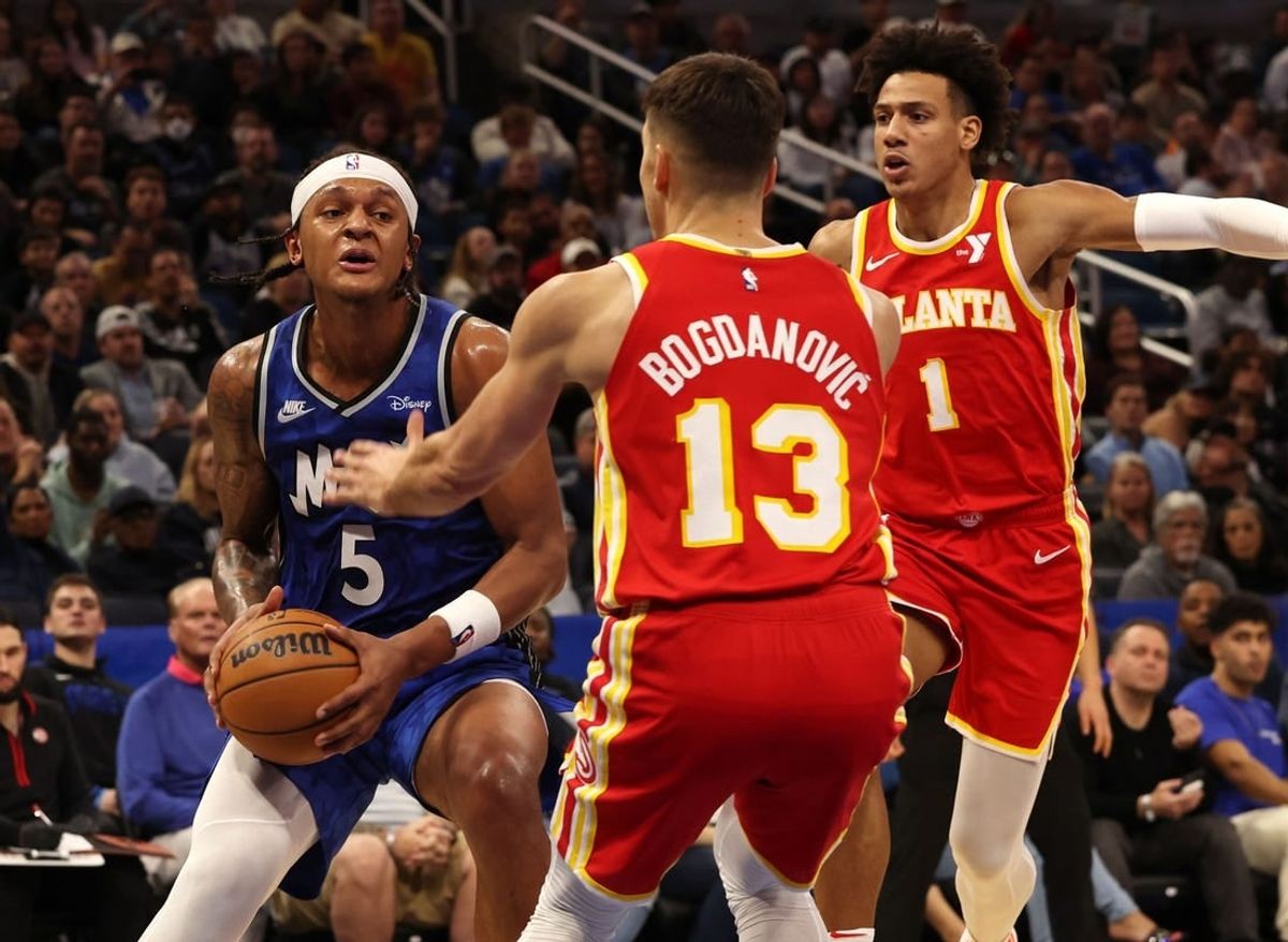 Jan 7, 2024; Orlando, Florida, USA; Orlando Magic forward Paolo Banchero (5) drives to the basket as Atlanta Hawks guard Bogdan Bogdanovic (13) defends during the second half at Kia Center.