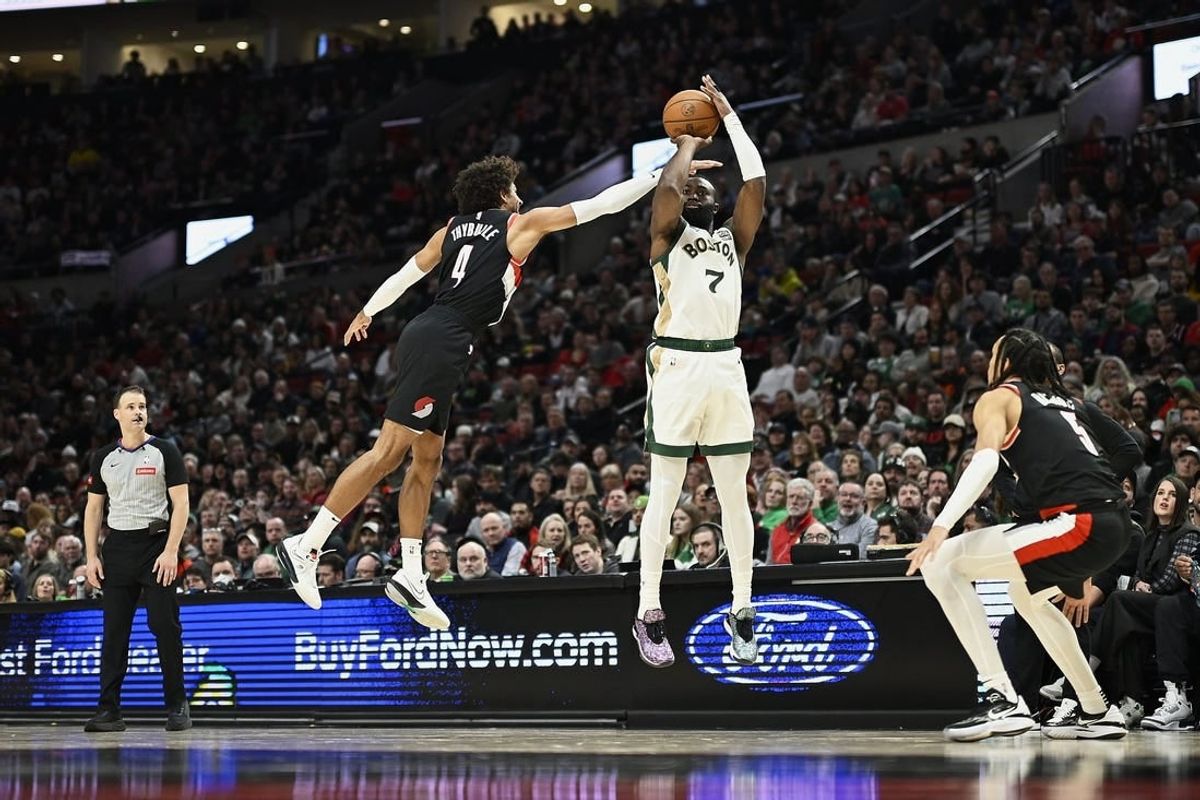 Mar 11, 2024; Portland, Oregon, USA; Boston Celtics guard Jaylen Brown (7) shoots a three point jump shot during the first half against Portland Trail Blazers guard Matisse Thybulle (4) and guard Dalano Banton (5) at Moda Center.