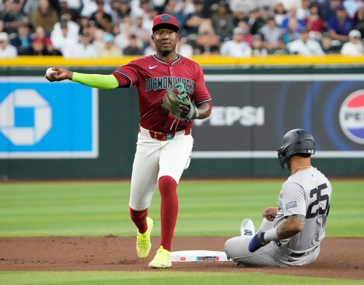Arizona Diamondbacks shortstop Geraldo Perdomo (2) throws to first after forcing out New York Yankees base runner Gleyber Torres (25) to complete a double play during the first inning at Chase Field in Phoenix on April 2, 2024.