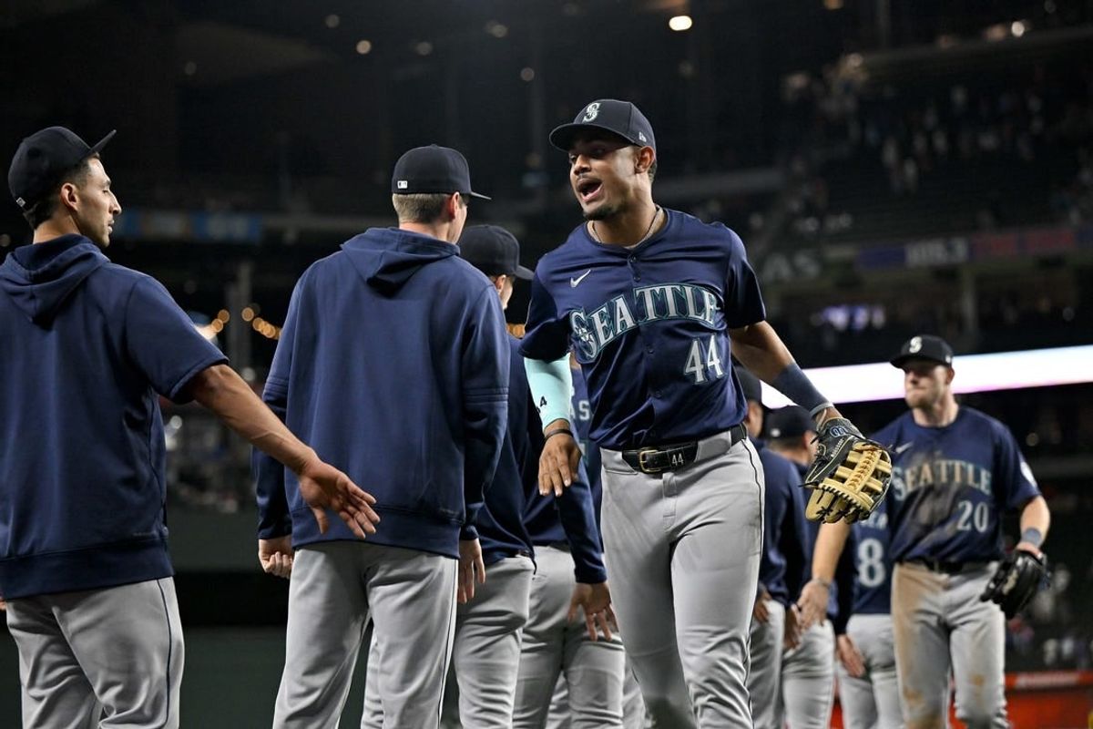 Apr 23, 2024; Arlington, Texas, USA; Seattle Mariners center fielder Julio Rodriguez (44) celebrates on the field with his teammates after Seattle defeats the Texas Rangers at Globe Life Field.