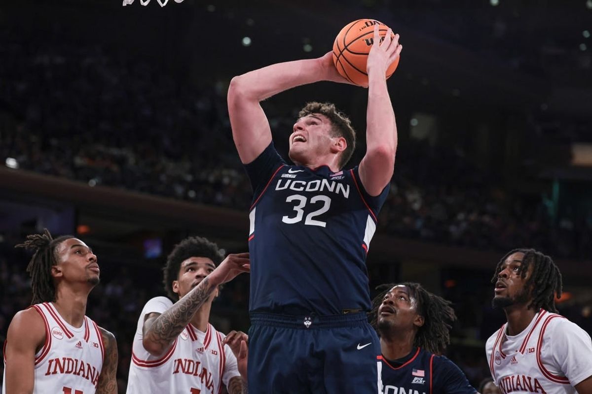 Nov 19, 2023; New York, New York, USA; Connecticut Huskies center Donovan Clingan (32) goes to the basket in front of Indiana Hoosiers center Kel'el Ware (1) and forward Mackenzie Mgbako (21) and guard Gabe Cupps (2) during the first half at Madison Square Garden.