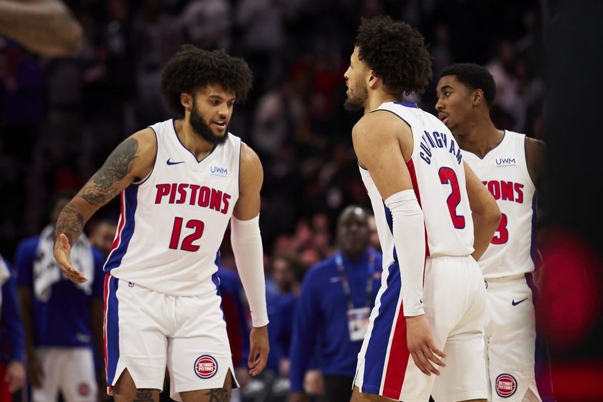 Dec 30, 2023; Detroit, Michigan, USA;  Detroit Pistons forward Isaiah Livers (12) and guard Cade Cunningham (2) celebrate after the game against the Toronto Raptors at Little Caesars Arena.