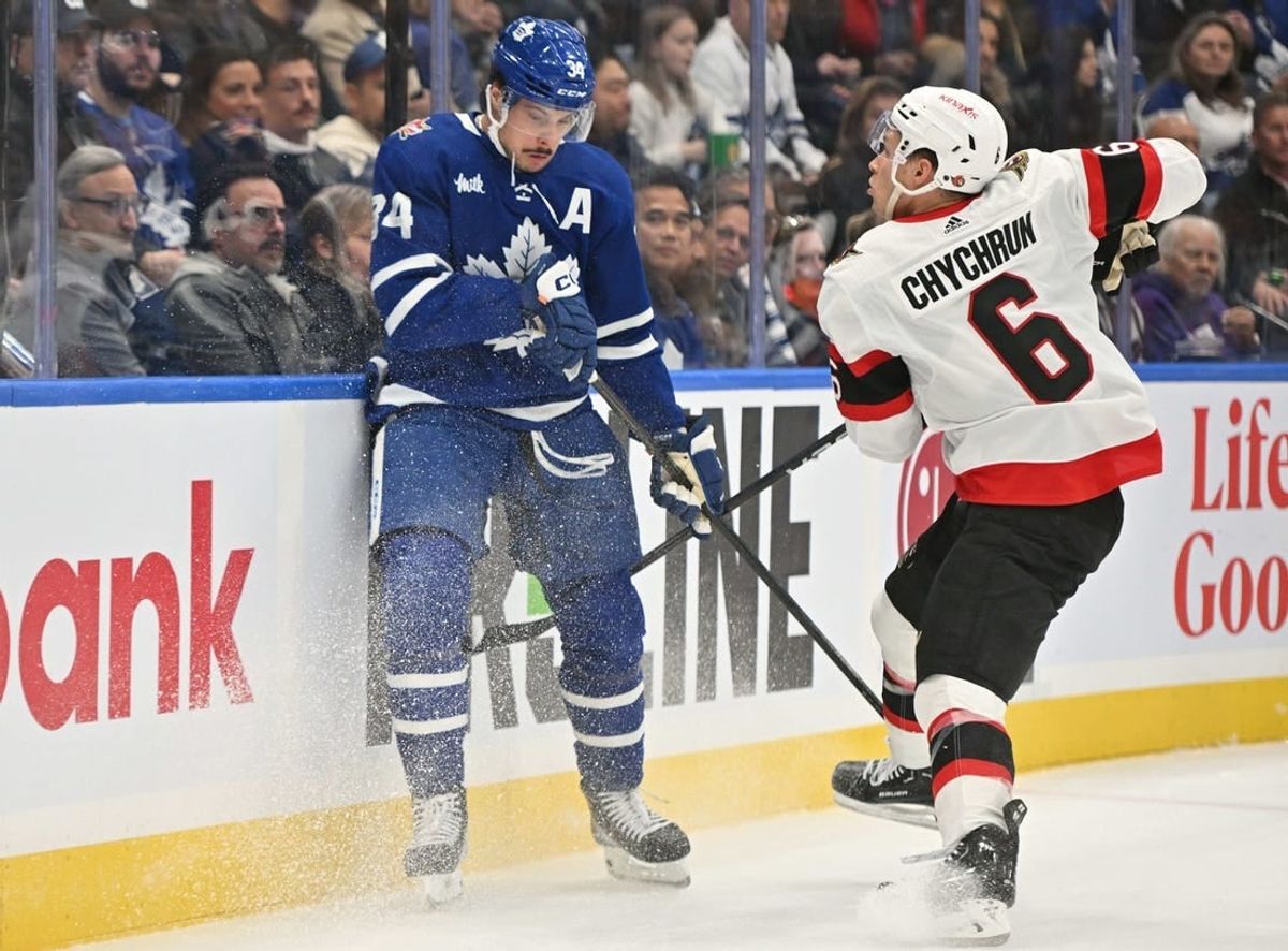 Nov 8, 2023; Toronto, Ontario, CAN; Ottawa Senators defenseman Jakob Chychrun (6) bodychecks Toronto Maple Leafs forward Auston Matthews (34) in the first period at Scotiabank Arena.