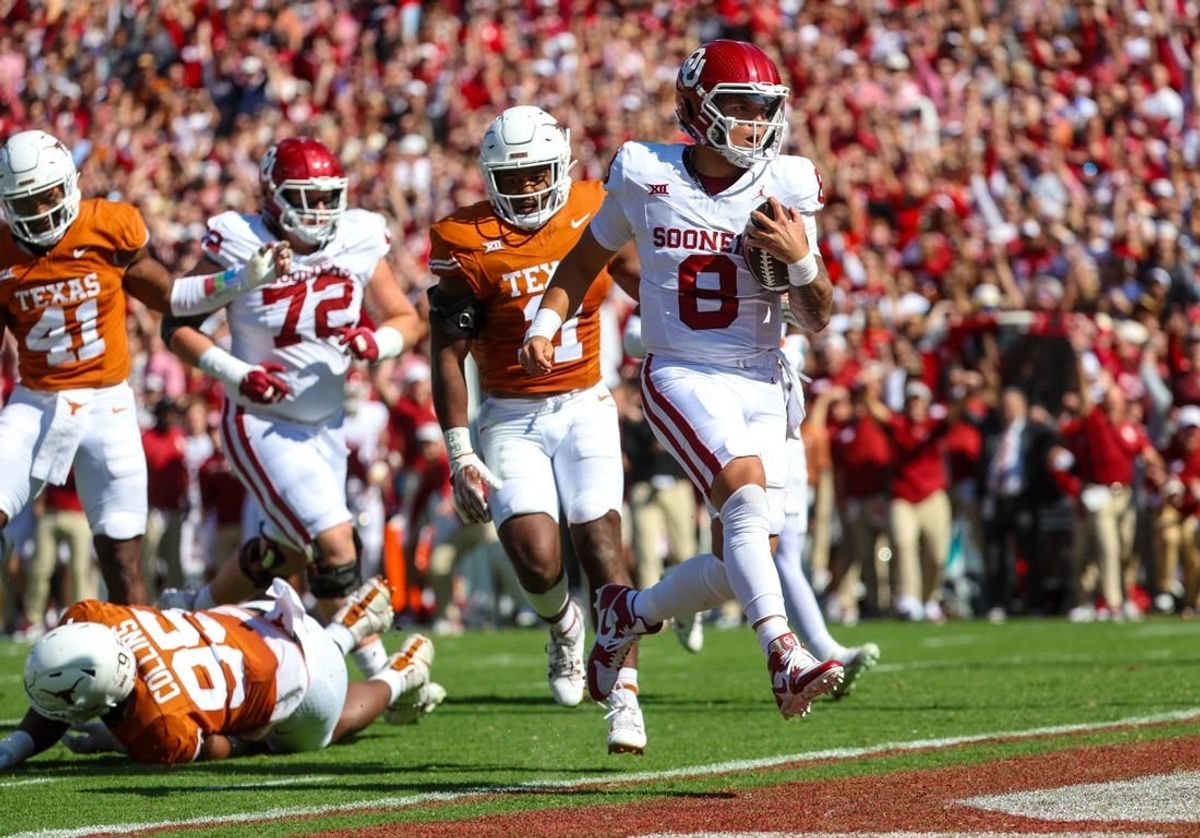 Oct 7, 2023; Dallas, Texas, USA;  Oklahoma Sooners quarterback Dillon Gabriel (8) runs for a touchdown during the first half against the Texas Longhorns at the Cotton Bowl.