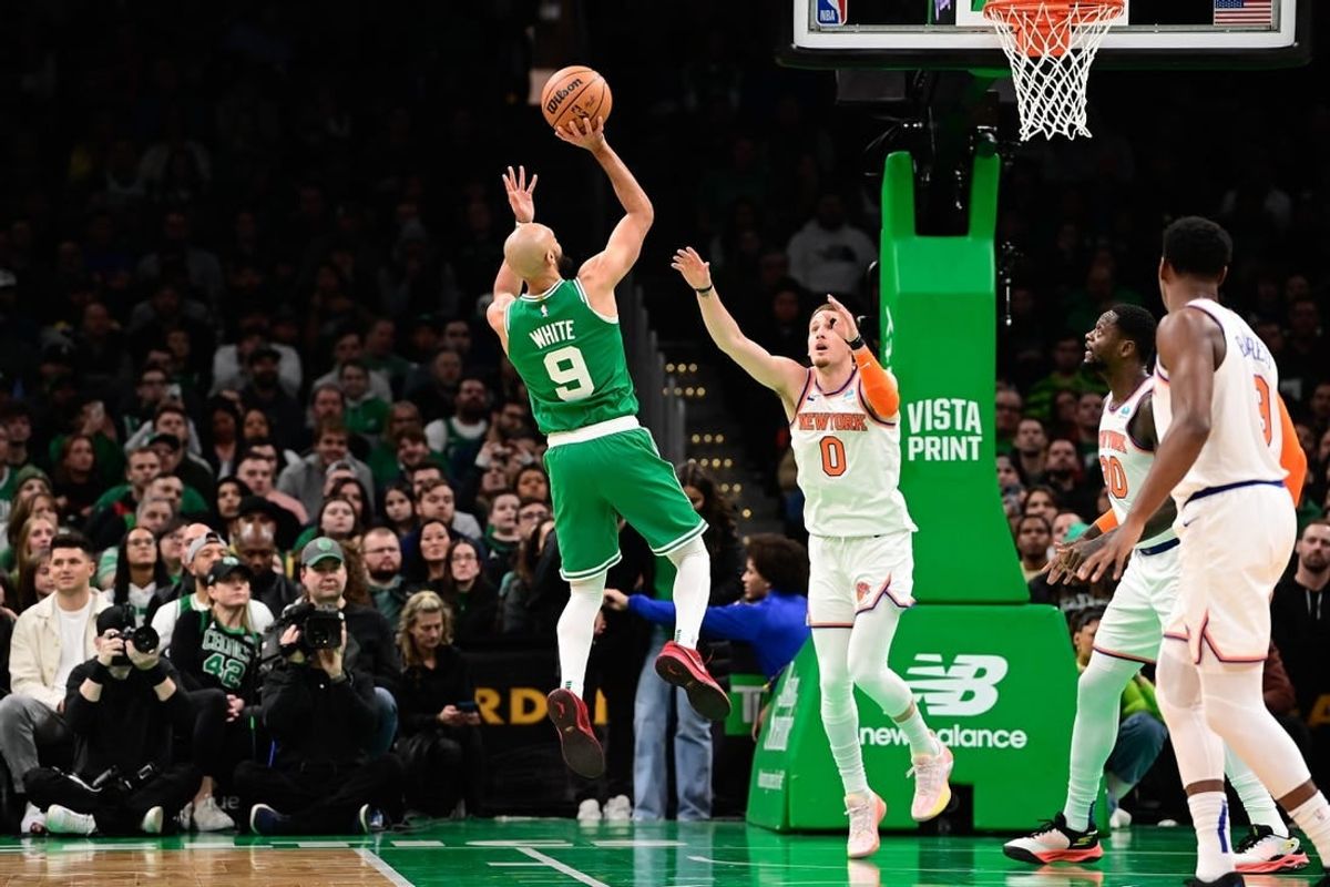 Dec 8, 2023; Boston, Massachusetts, USA;  Boston Celtics guard Derrick White (9) shoots over New York Knicks guard Donte DiVincenzo (0) during the first half at TD Garden.