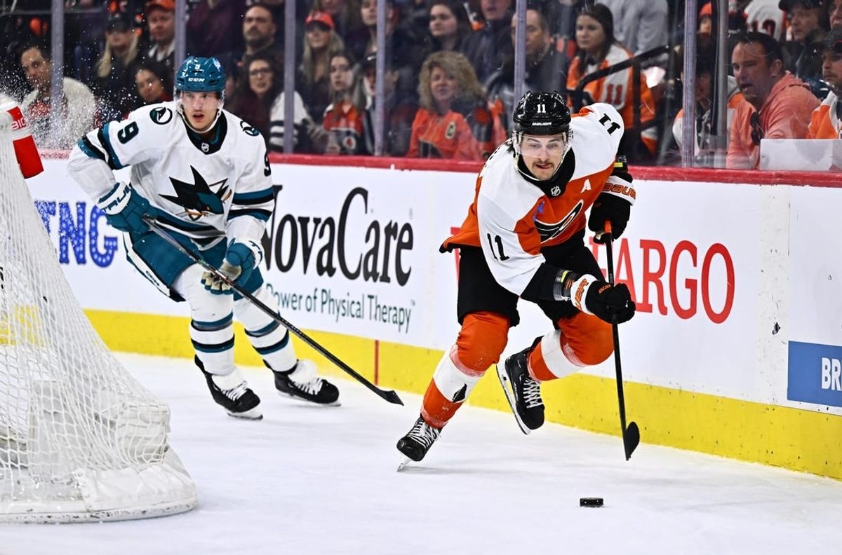 Mar 12, 2024; Philadelphia, Pennsylvania, USA; Philadelphia Flyers right wing Travis Konecny (11) reaches for the puck against the San Jose Sharks in the first period at Wells Fargo Center.