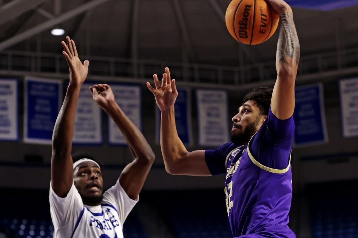 Dec 16, 2023; Hampton, Virginia, USA; James Madison Dukes forward Julien Wooden (22) dunks the ball against Hampton Pirates forward Ja'Von Benson (21) during the first half at Hampton Convocation Center.