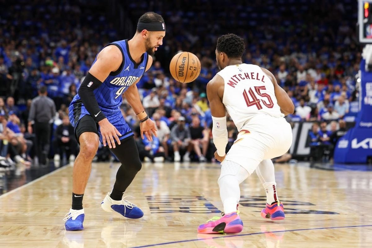 Apr 27, 2024; Orlando, Florida, USA; Cleveland Cavaliers guard Donovan Mitchell (45) steals the ball from Orlando Magic guard Jalen Suggs (4) in the first quarter during game three of the first round for the 2024 NBA playoffs at Kia Center.