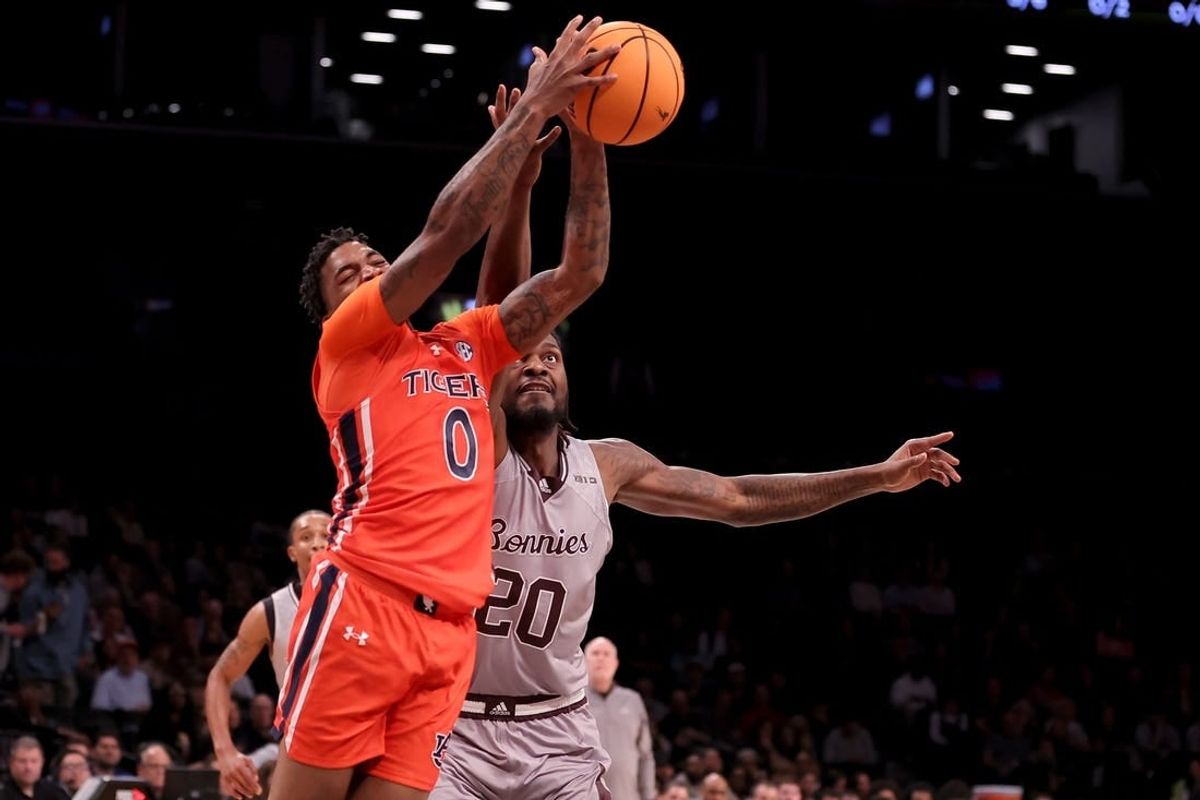 Nov 17, 2023; Brookyln, NY, USA; Auburn Tigers guard K.D. Johnson (0) grabs a rebound against St. Bonaventure Bonnies center Noel Brown (20) during the first half at Barclays Center.