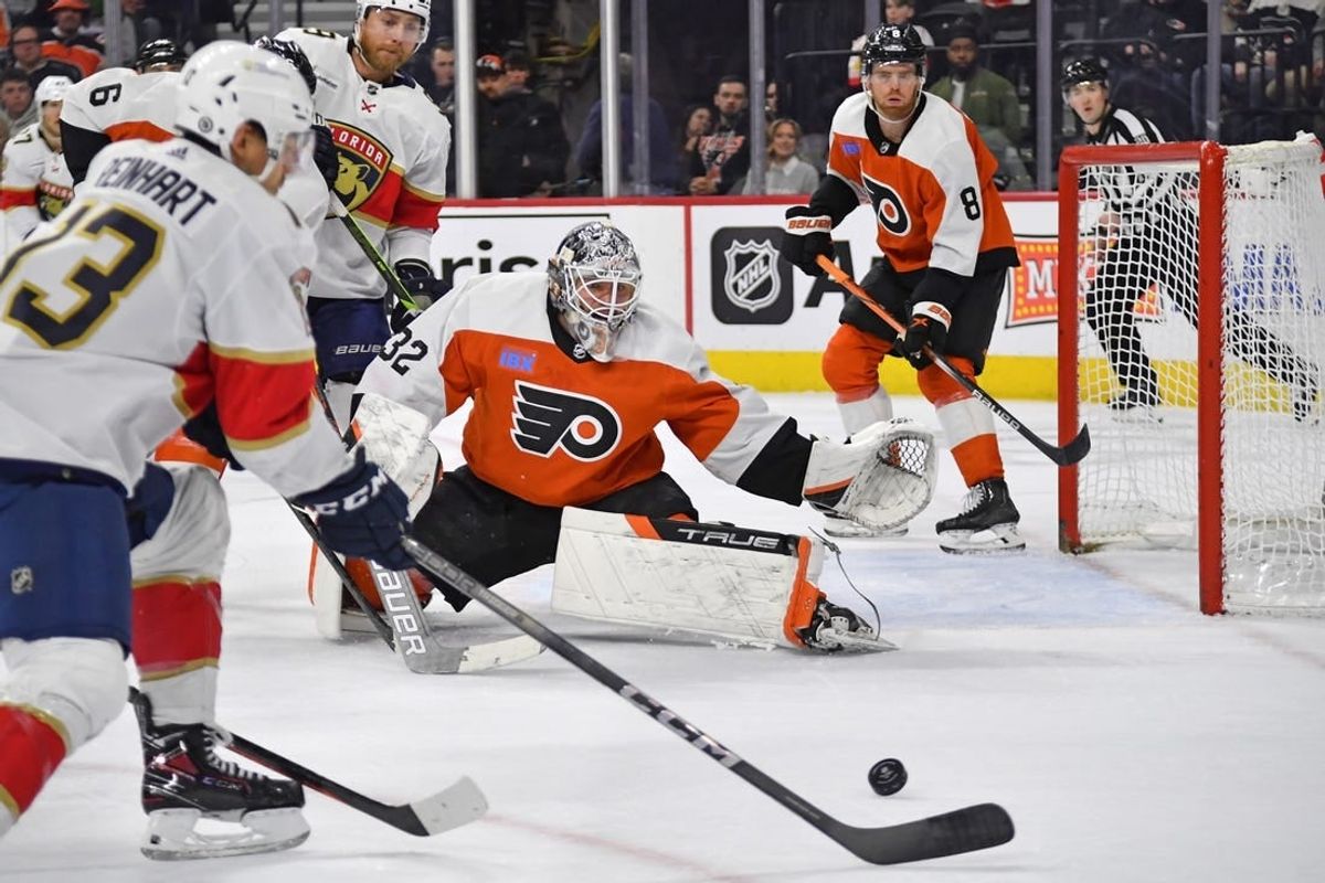 Mar 24, 2024; Philadelphia, Pennsylvania, USA; Philadelphia Flyers goaltender Felix Sandstrom (32) defends as Florida Panthers center Sam Reinhart (13) reaches for the puck during the second period at Wells Fargo Center.