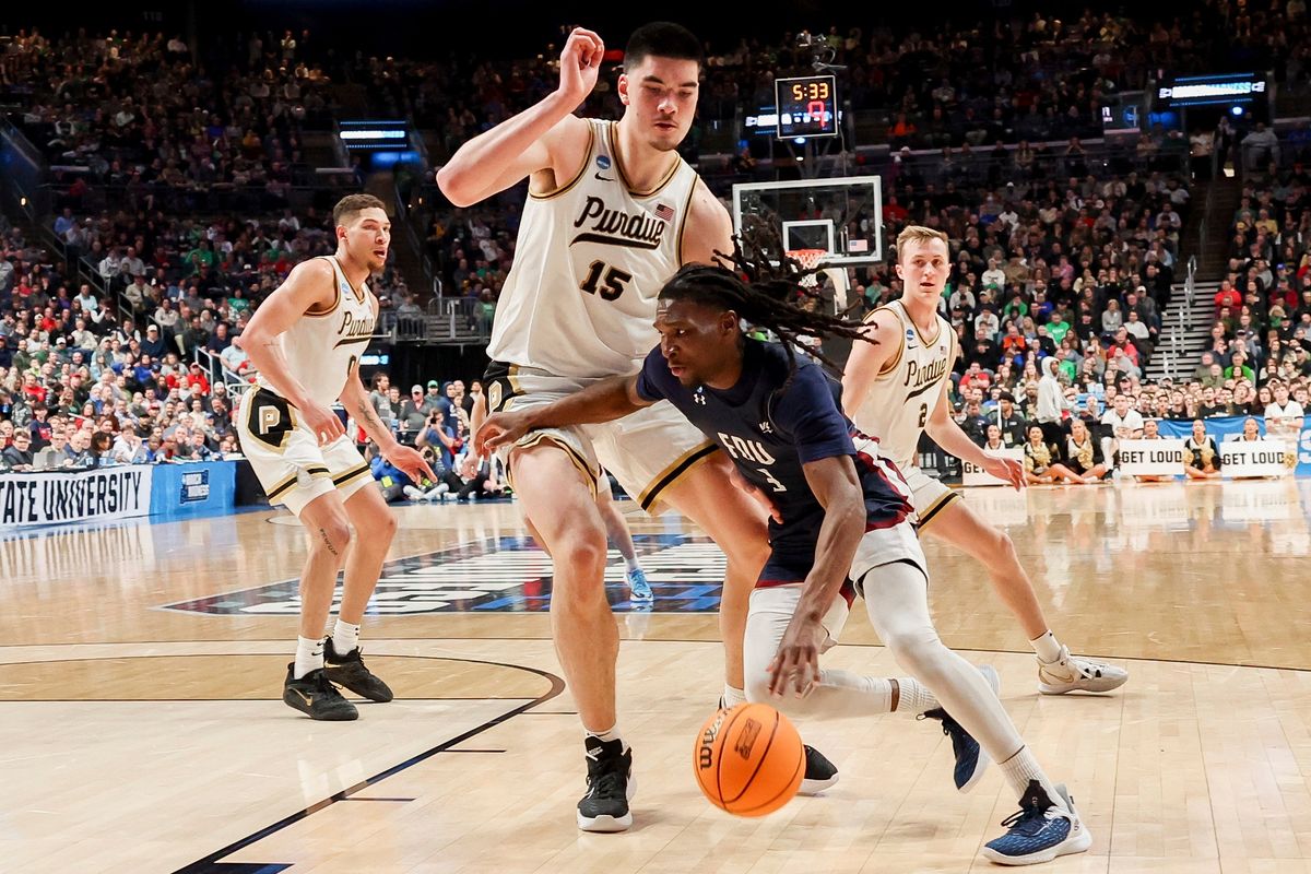 Fairleigh Dickinson Knights guard Heru Bligen drives against Purdue Boilermakers center Zach Edey.