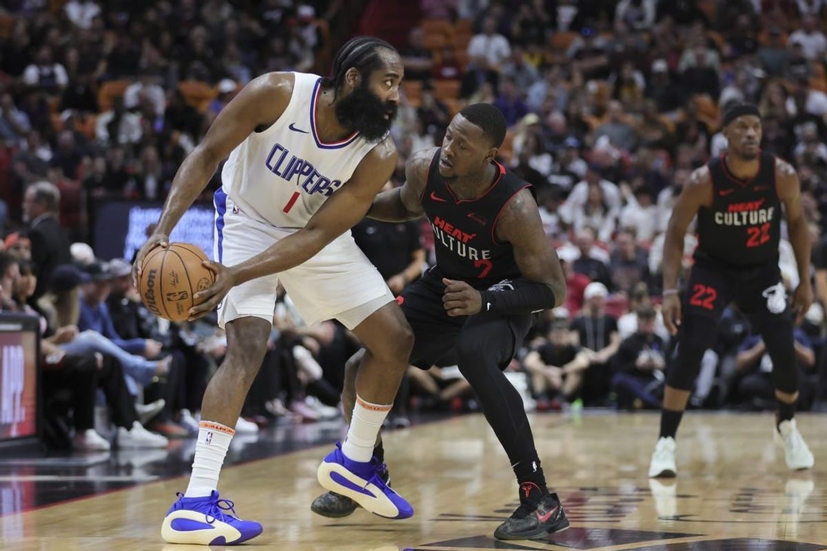 Feb 4, 2024; Miami, Florida, USA; LA Clippers guard James Harden (1) protects the basketball from Miami Heat guard Terry Rozier (2) during the first quarter at Kaseya Center.