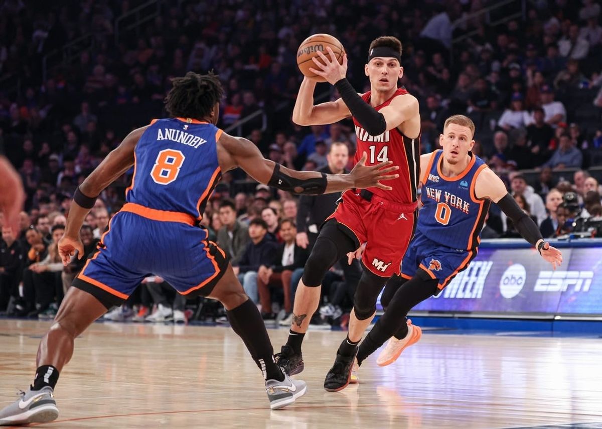 Jan 27, 2024; New York, New York, USA; Miami Heat guard Tyler Herro (14) drives to the basket after the game New York Knicks forward OG Anunoby (8) and guard Donte DiVincenzo (0) during the first half at Madison Square Garden.