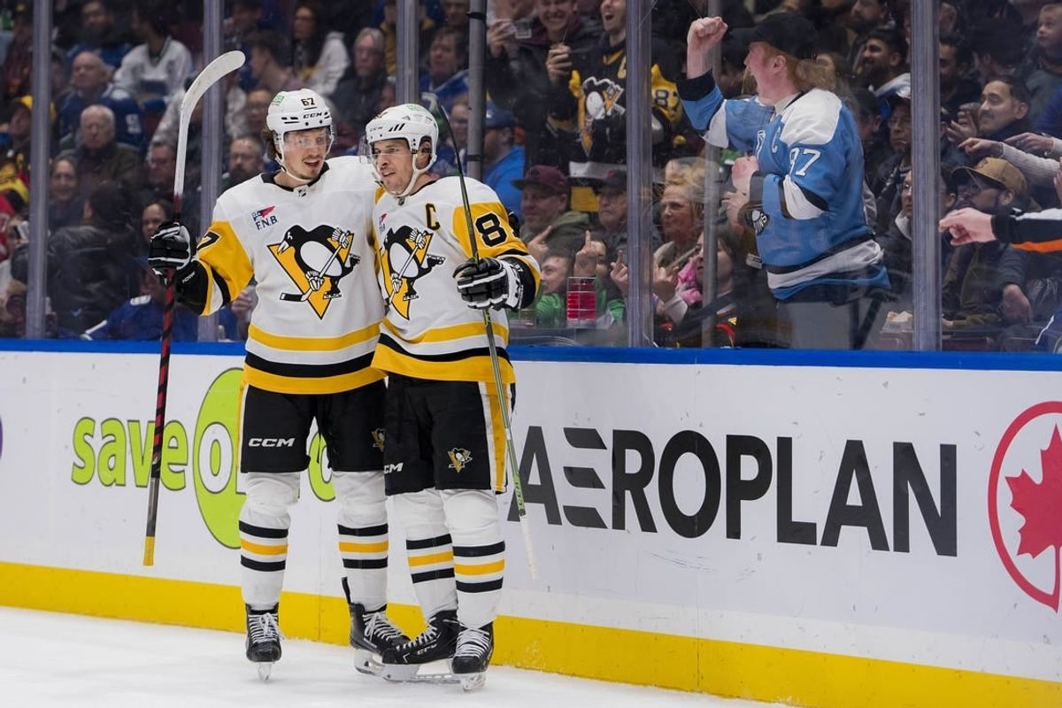 Feb 27, 2024; Vancouver, British Columbia, CAN; Pittsburgh Penguins forward Rickard Rakell (67) and forward Sidney Crosby (87) celebrate Rakell   s second goal of the game against the Vancouver Canucks in the second period at Rogers Arena.