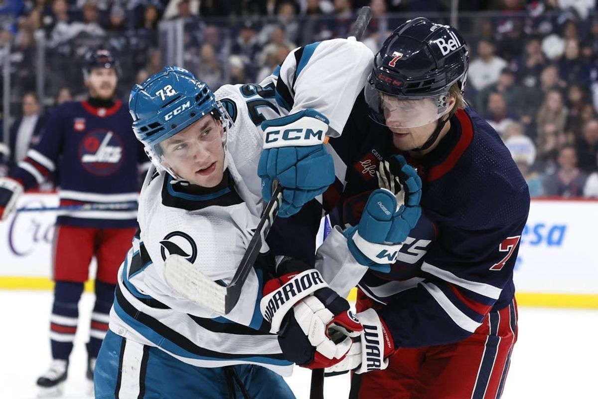 Feb 14, 2024; Winnipeg, Manitoba, CAN; San Jose Sharks left wing William Eklund (72) and Winnipeg Jets center Vladislav Namestnikov (7) tangle up in the second period at Canada Life Centre.
