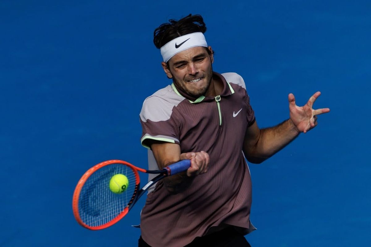 Jan 23, 2024; Melbourne, Victoria, Australia;  Taylor Fritz of the United States in action against Novak Djokovic of Serbia in the quarter final of the men s singles.