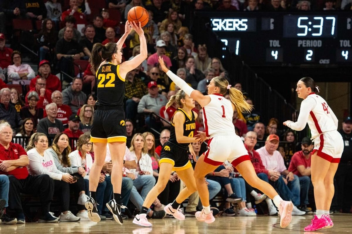 Feb 11, 2024; Lincoln, Nebraska, USA; Iowa Hawkeyes guard Caitlin Clark (22) shoots a three point shot against Nebraska Cornhuskers guard Jaz Shelley (1) during the second quarter at Pinnacle Bank Arena.