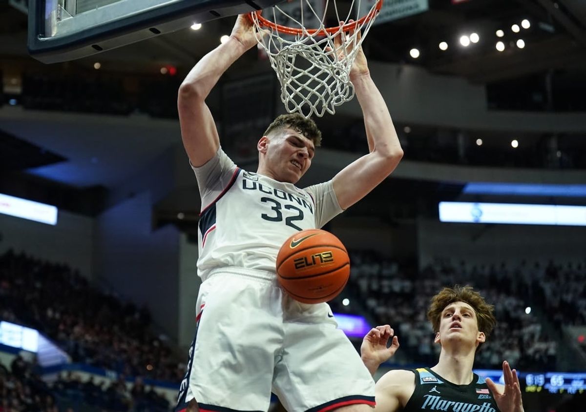 Feb 17, 2024; Hartford, Connecticut, USA; UConn Huskies center Donovan Clingan (32) makes the basket against the Marquette Golden Eagles in the second half at XL Center.
