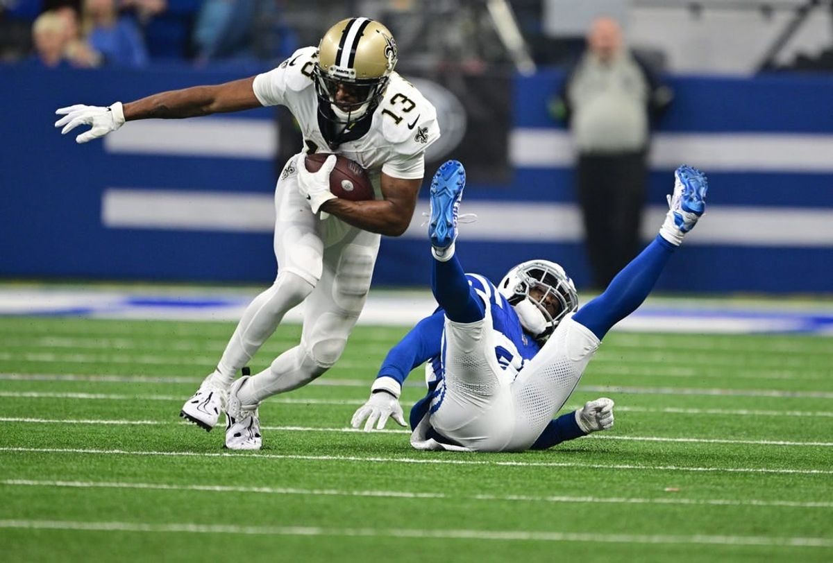 Oct 29, 2023; Indianapolis, Indiana, USA; New Orleans Saints wide receiver Michael Thomas (13) evades a tackle by Indianapolis Colts cornerback Tony Brown (38) during the first quarter at Lucas Oil Stadium.