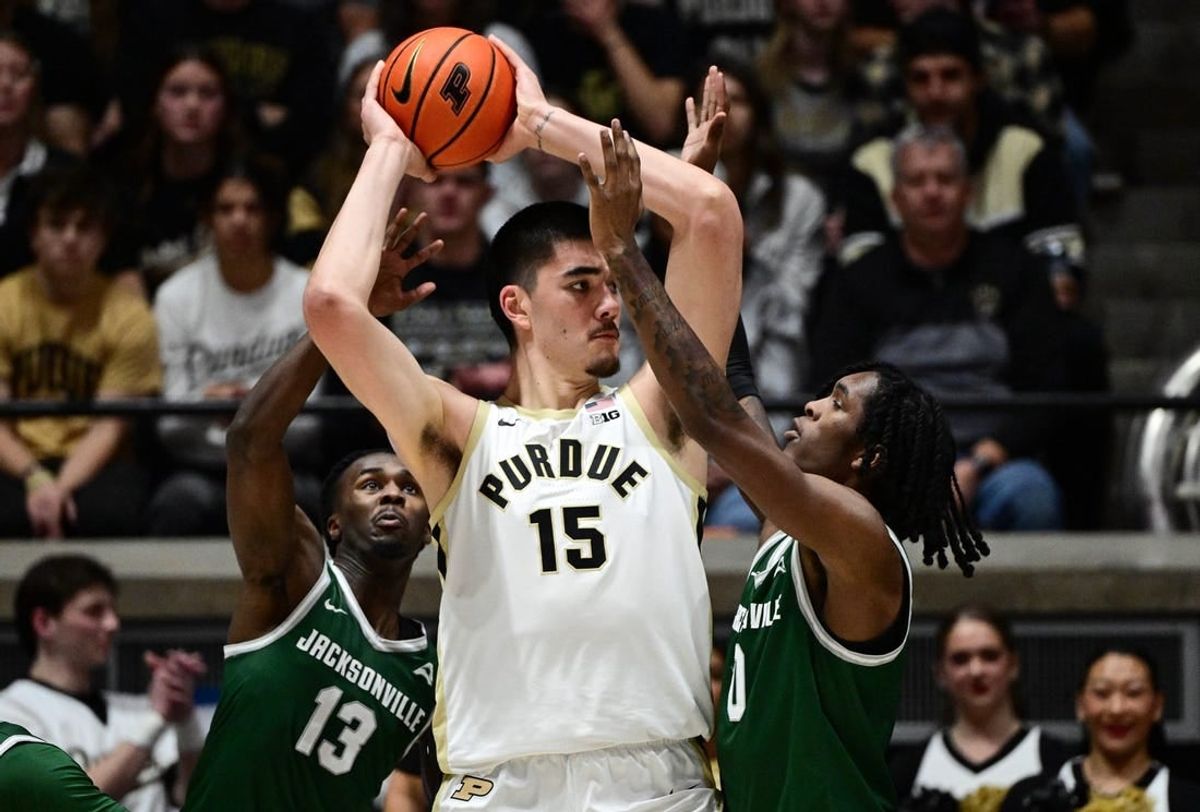 Dec 21, 2023; West Lafayette, Indiana, USA;  Purdue Boilermakers center Zach Edey (15) keeps the ball away from Jacksonville Dolphins guard Robert McCray V (13) and forward Stephon Payne III (0) right, during the first half at Mackey Arena.
