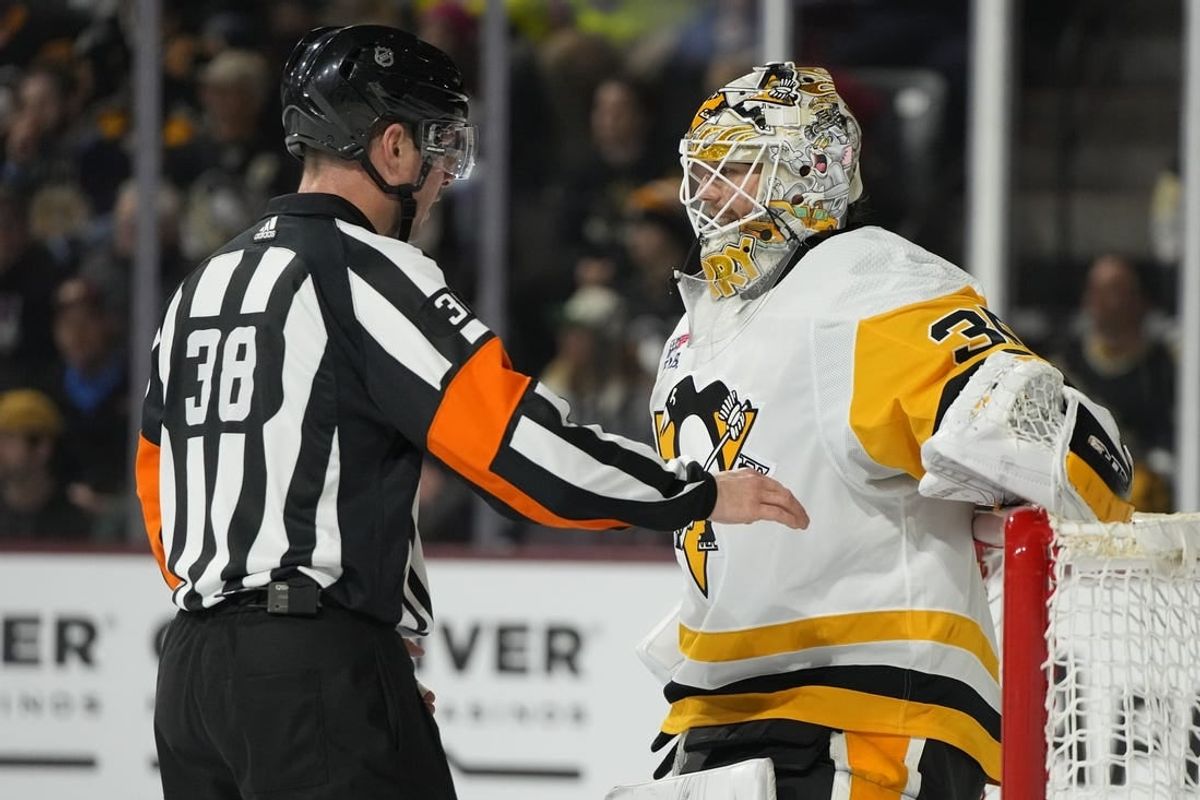 Jan 22, 2024; Tempe, Arizona, USA; Pittsburgh Penguins goaltender Tristan Jarry (35) talks to NHL referee Peter McDougall during a timeout in the second period against the Arizona Coyotes at Mullett Arena.
