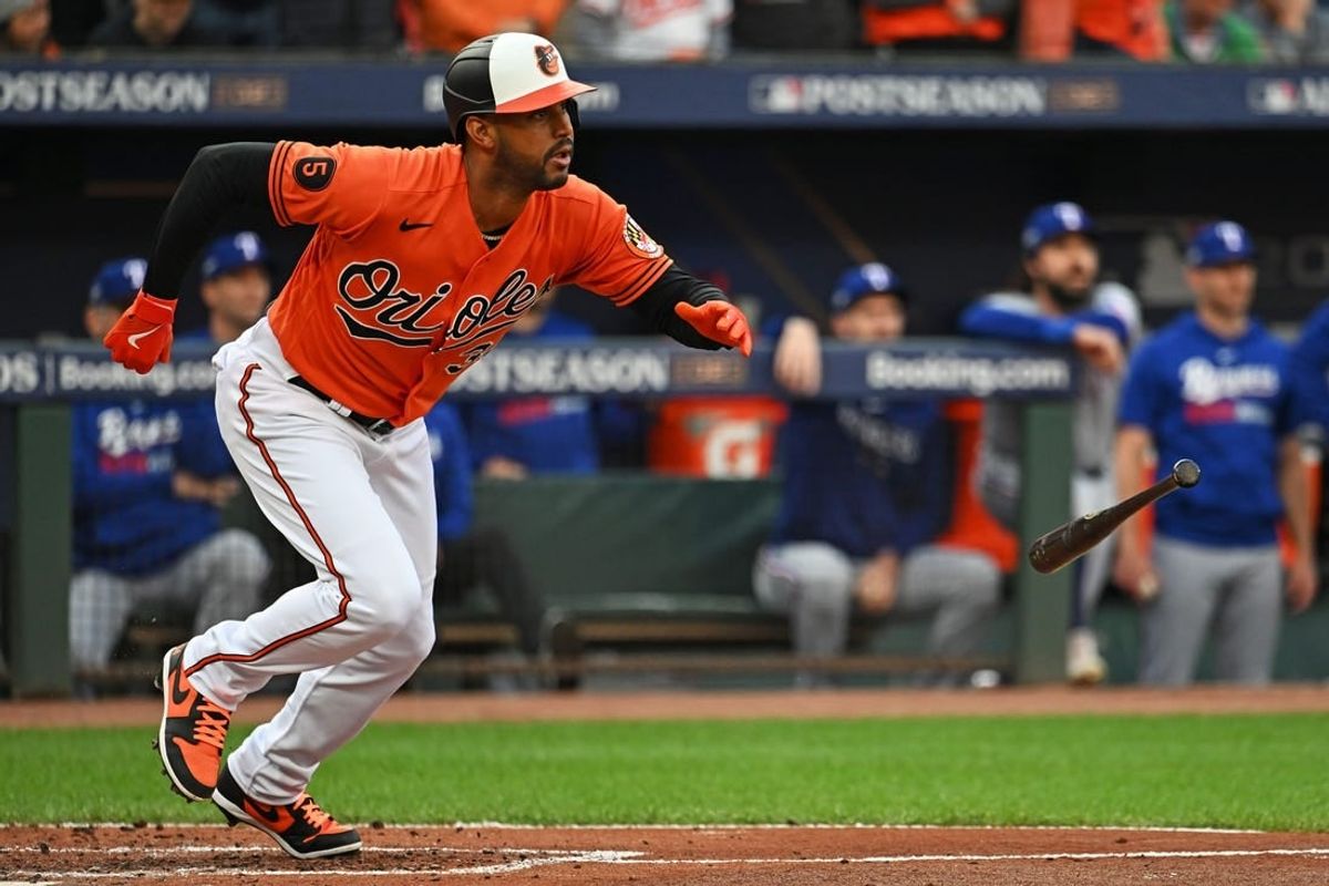 Oct 8, 2023; Baltimore, Maryland, USA; Baltimore Orioles center fielder Aaron Hicks (34) hits a two run RBI during the first inning against the Texas Rangers during game two of the ALDS for the 2023 MLB playoffs at Oriole Park at Camden Yards.