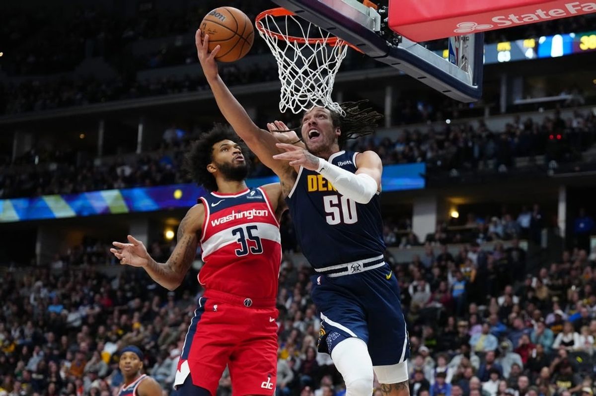 Feb 22, 2024; Denver, Colorado, USA; Denver Nuggets forward Aaron Gordon (50) shoots past Washington Wizards forward Marvin Bagley III (35) in the second quarter at Ball Arena.
