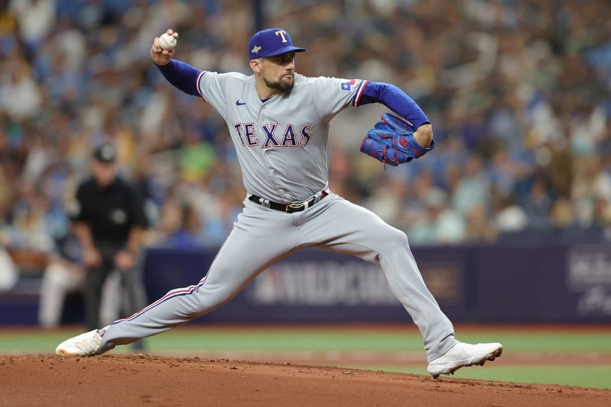 Oct 4, 2023; St. Petersburg, Florida, USA; Texas Rangers starting pitcher Nathan Eovaldi (17) pitches against the Tampa Bay Rays in the first inning during game two of the Wildcard series for the 2023 MLB playoffs at Tropicana Field.