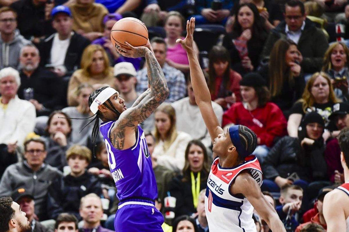 Mar 4, 2024; Salt Lake City, Utah, USA; Utah Jazz guard Jordan Clarkson (00) shoots over Washington Wizards guard Bilal Coulibaly (0) during the first half at the Delta Center.