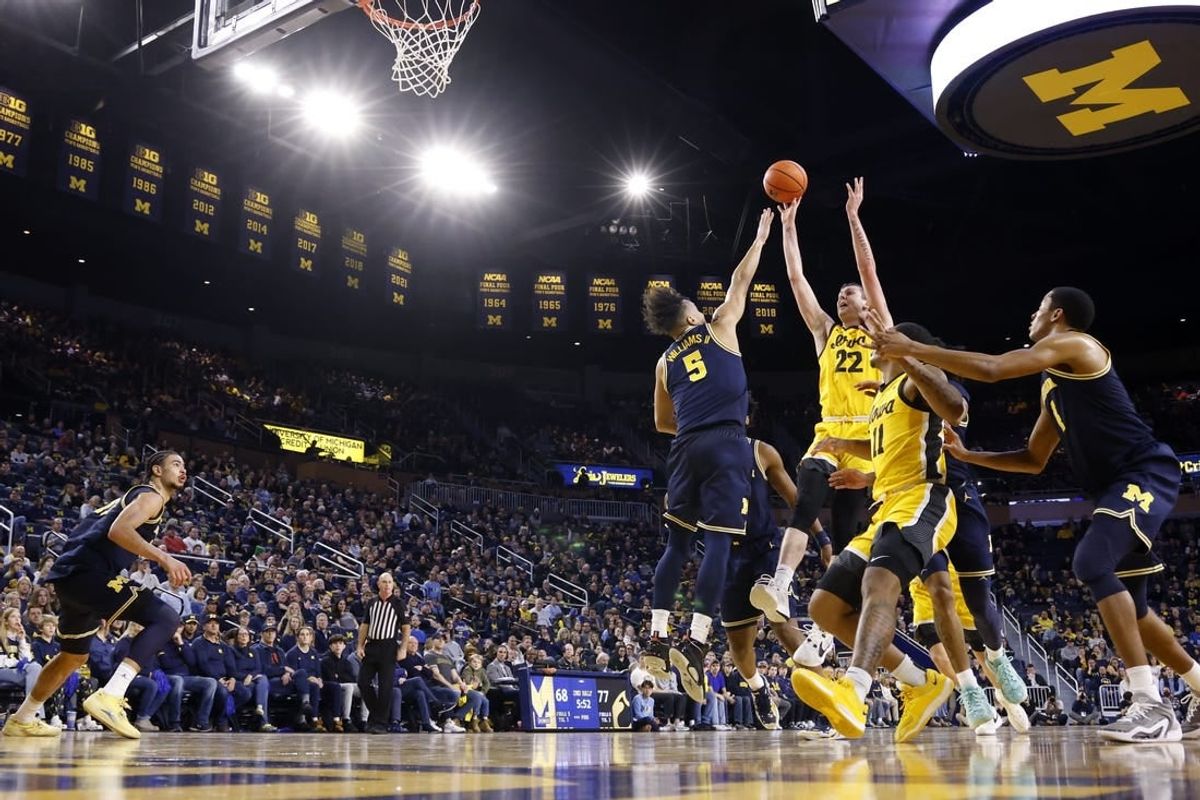 Jan 27, 2024; Ann Arbor, Michigan, USA; Iowa Hawkeyes forward Patrick McCaffery (22) shoots on Michigan Wolverines forward Terrance Williams II (5) in the second half at Crisler Center.