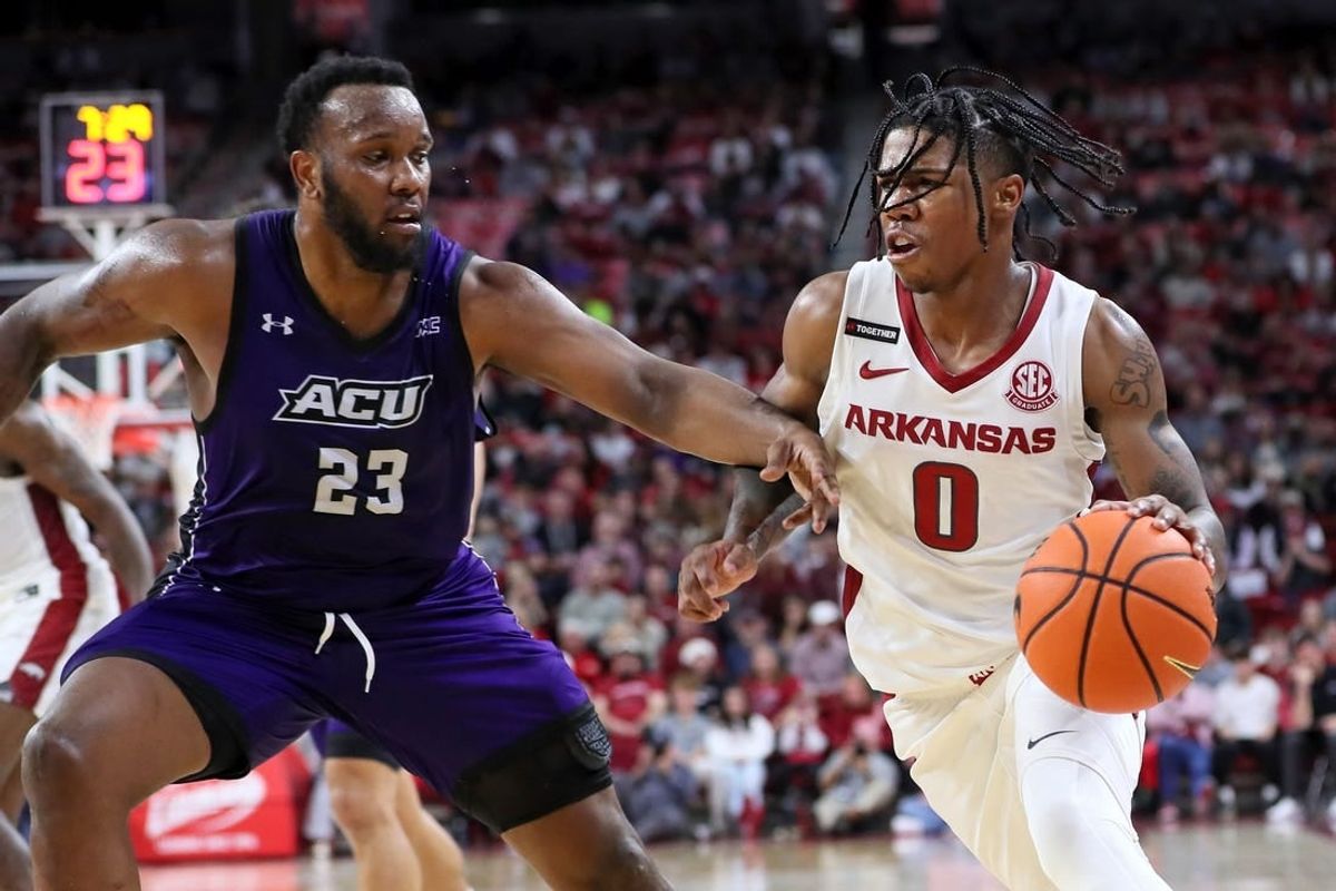 Dec 21, 2023; Fayetteville, Arkansas, USA; Arkansas Razorbacks guard Khalif Battle (0) drives against Abilene Christian Wildcats forward Airion Simmons (23) during the second half at Bud Walton Arena. Arkansas won 83-73.
