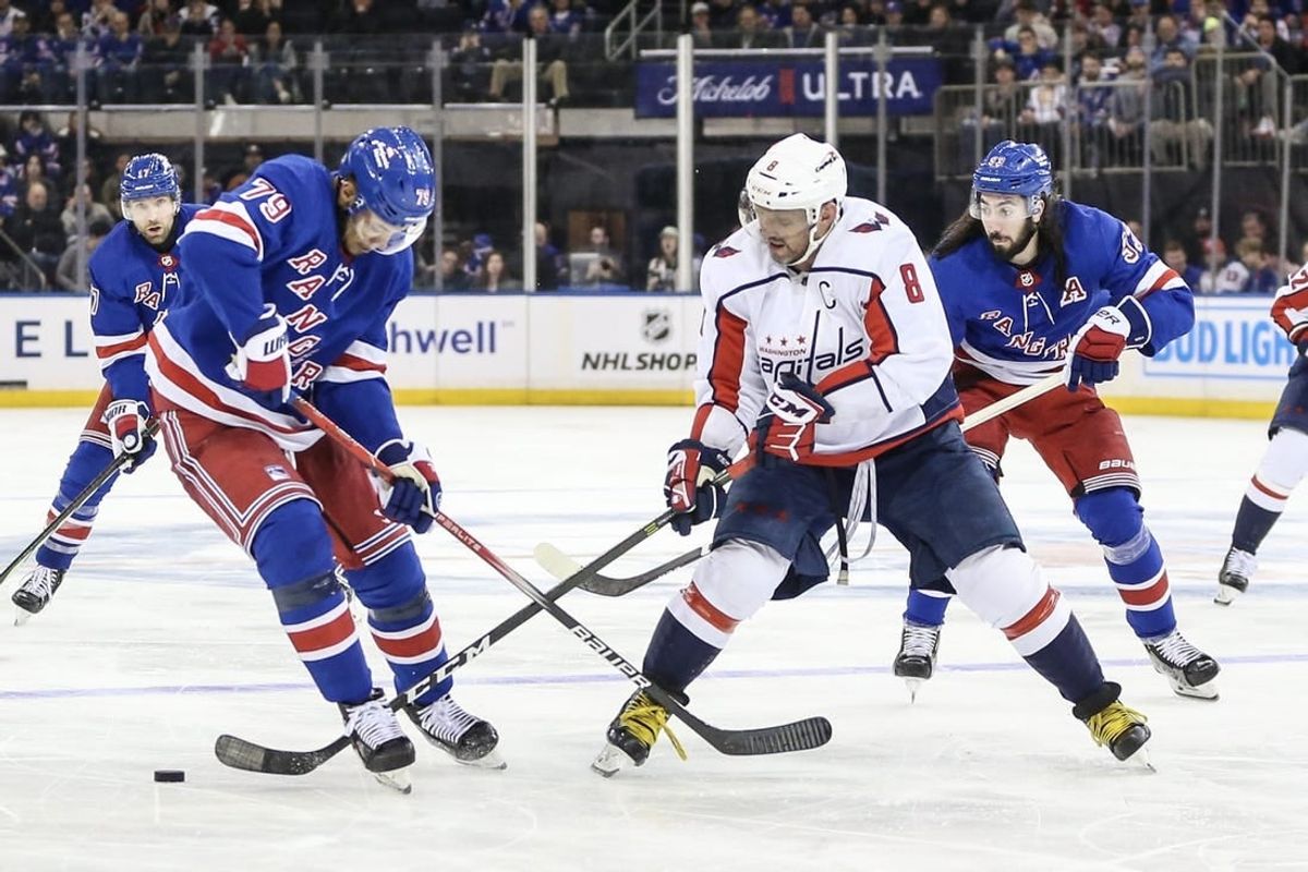 Dec 27, 2023; New York, New York, USA; New York Rangers defenseman K'Andre Miller (79) and Washington Capitals left wing Alex Ovechkin (8) battle for control of the puck in the third period at Madison Square Garden.