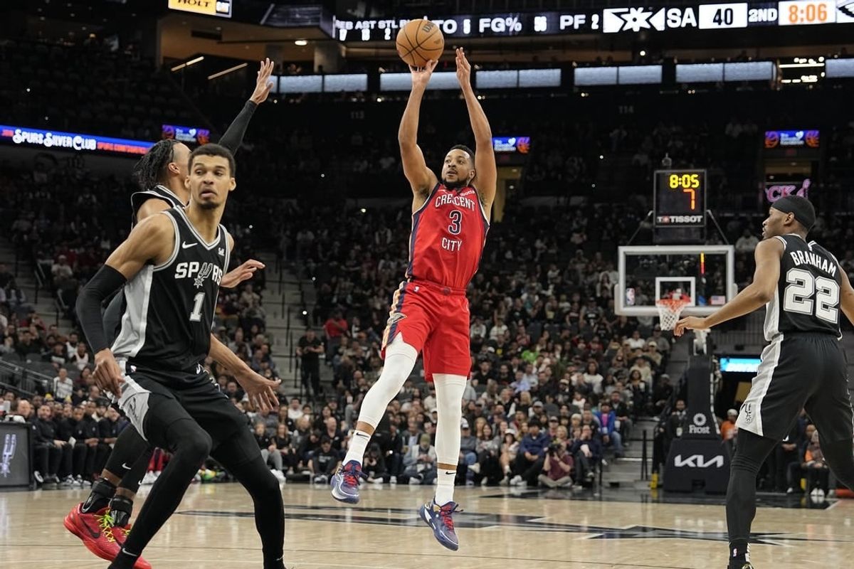 Feb 2, 2024; San Antonio, Texas, USA; New Orleans Pelicans guard CJ McCollum (3) shoots during the first half against the San Antonio Spurs at Frost Bank Center.