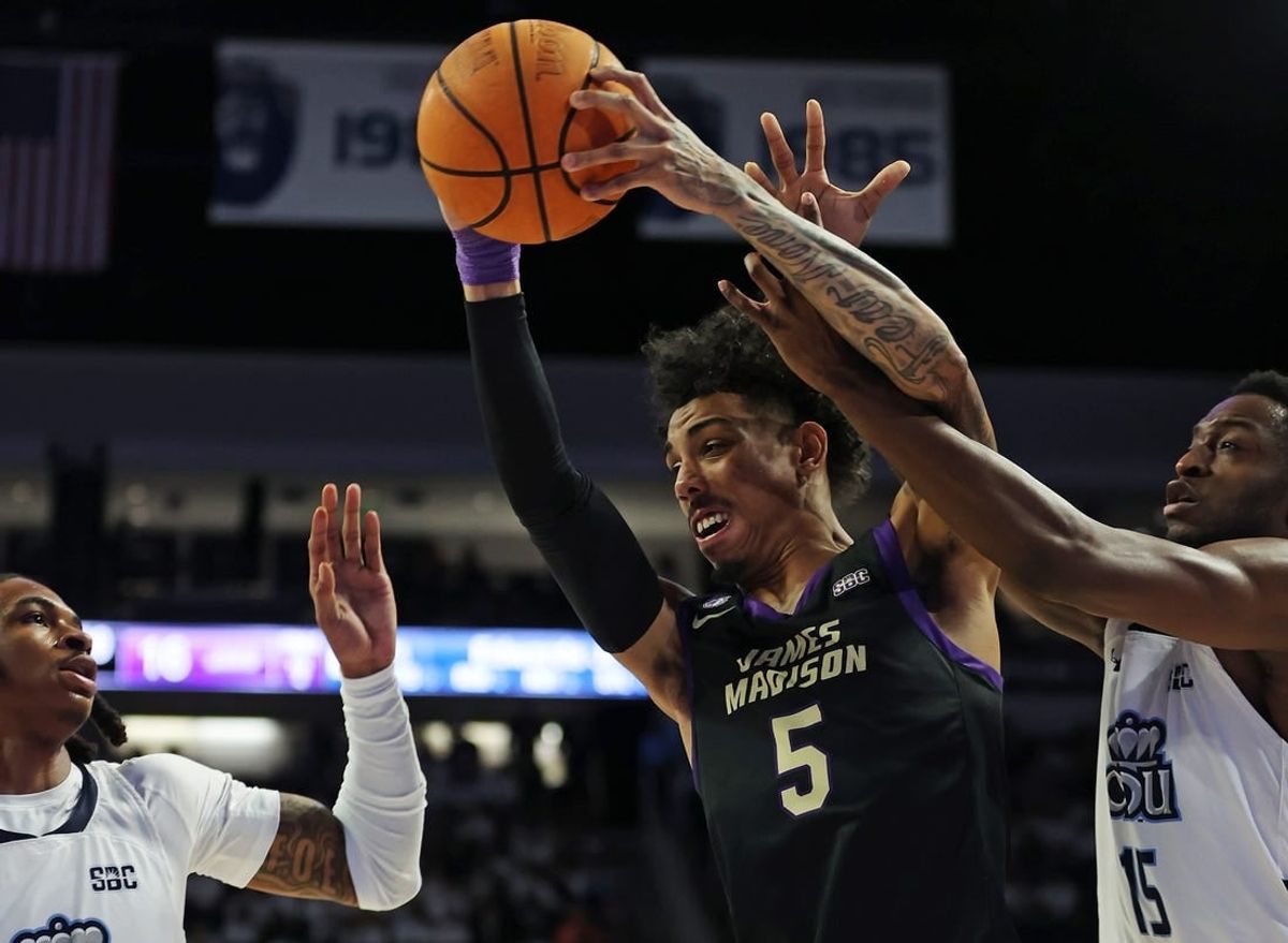Dec 9, 2023; Norfolk, Virginia, USA; James Madison Dukes guard Terrence Edwards (5) drives to the basket against Old Dominion Monarchs guard Chaunce Jenkins (2) guard R.J. Blakney (15) at Chartway Arena at the Ted Constant Convocation Center.