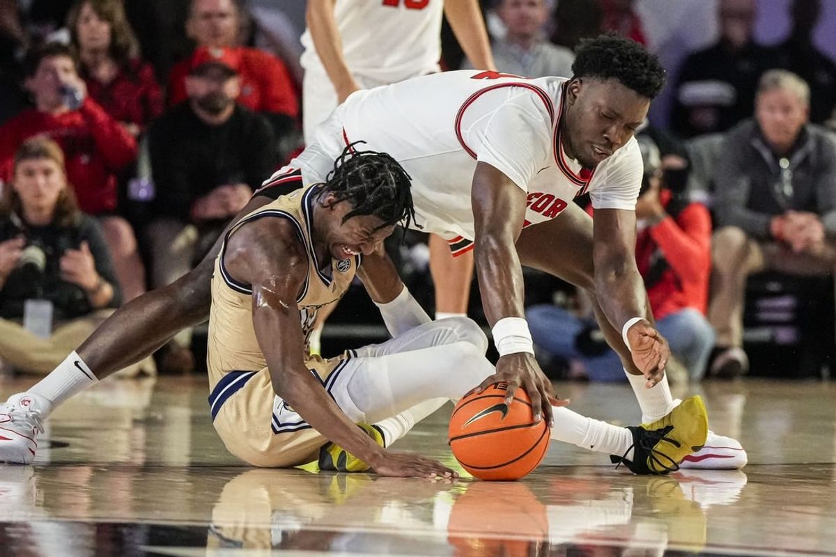Dec 5, 2023; Athens, Georgia, USA; Georgia Tech Yellow Jackets guard Miles Kelly (13) and Georgia Bulldogs center Russel Tchewa (54) fight for the ball during the first half at Stegeman Coliseum.