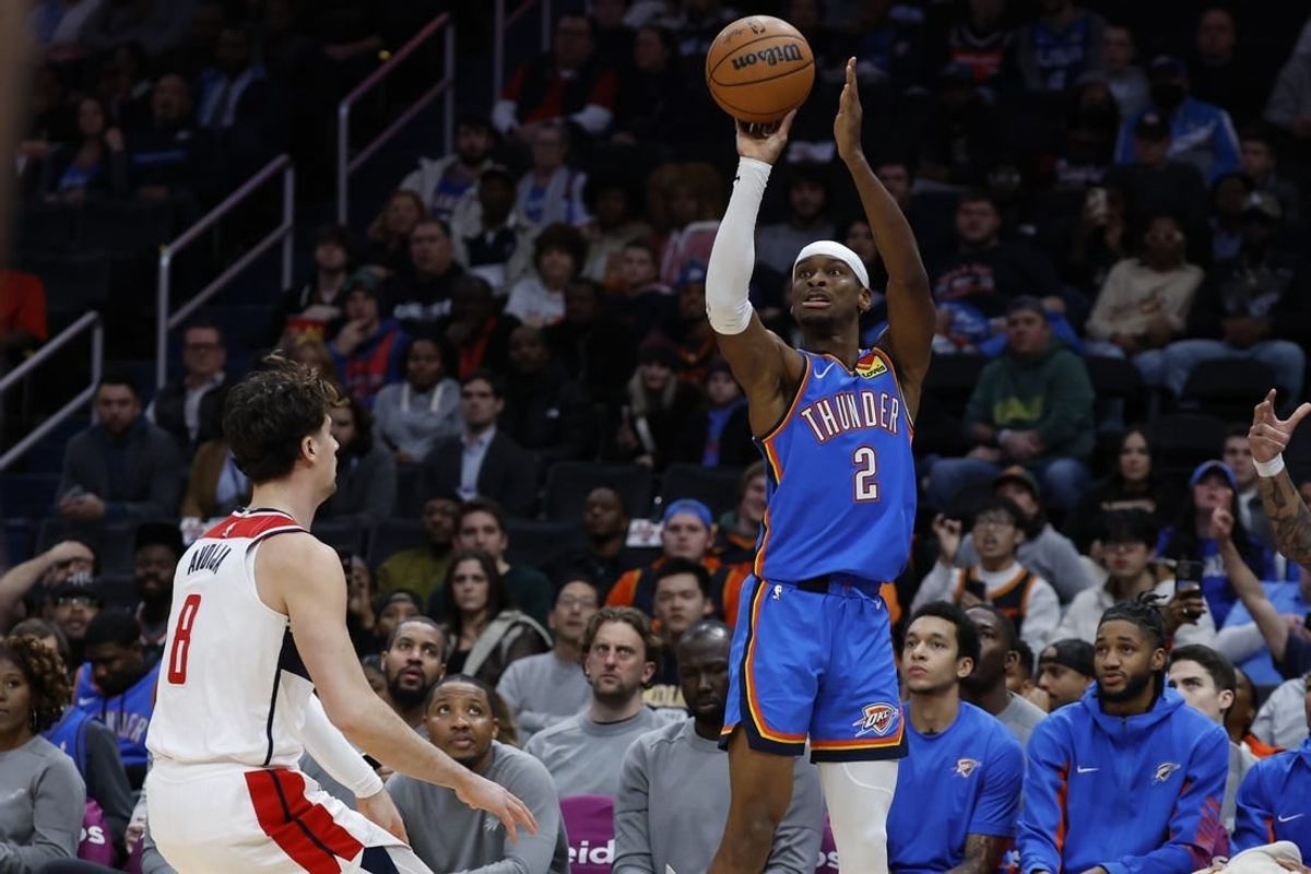Jan 8, 2024; Washington, District of Columbia, USA; Oklahoma City Thunder guard Shai Gilgeous-Alexander (2) shoots the ball over Washington Wizards forward Deni Avdija (8) in the first quarter at Capital One Arena.