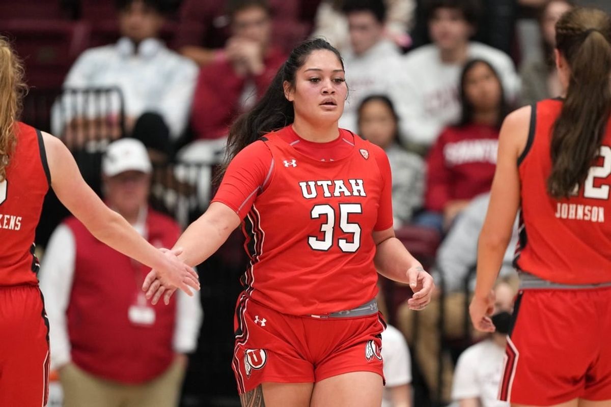 (File photo) Utah Utes forward Alissa Pili (35) is congratulated by guard Gianna Kneepkens (left) and forward Jenna Johnson (right) during the third quarter against the Stanford Cardinal at Maples Pavilion.