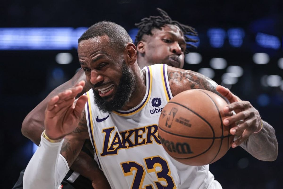 Mar 31, 2024; Brooklyn, New York, USA; Los Angeles Lakers forward LeBron James (23) drives to the basket against Brooklyn Nets forward Trendon Watford (9) during the second half at Barclays Center.