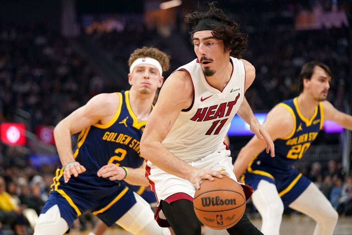 Dec 28, 2023; San Francisco, California, USA; Miami Heat forward Jaime Jaquez Jr. (11) spins towards the hoop next to Golden State Warriors guard Brandin Podziemski (2) in the first quarter at the Chase Center.