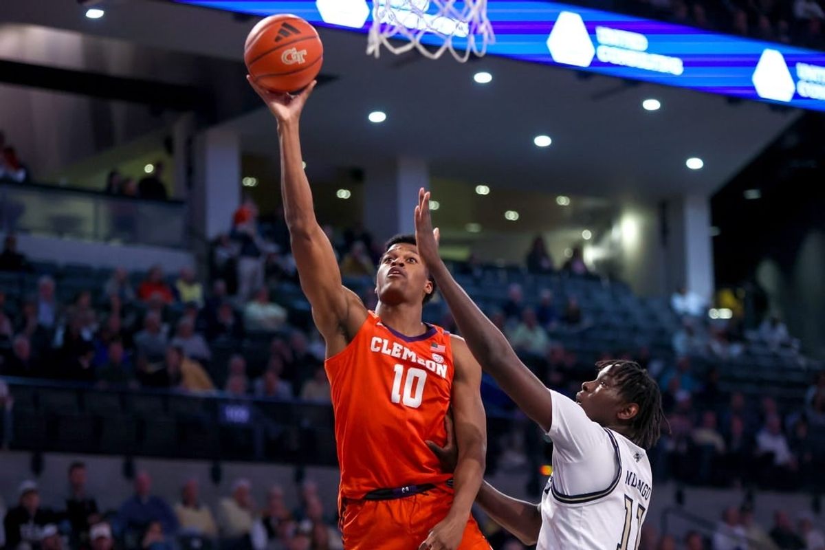 Feb 21, 2024; Atlanta, Georgia, USA; Clemson Tigers forward RJ Godfrey (10) shoots past Georgia Tech Yellow Jackets forward Baye Ndongo (11) in the first half at McCamish Pavilion.