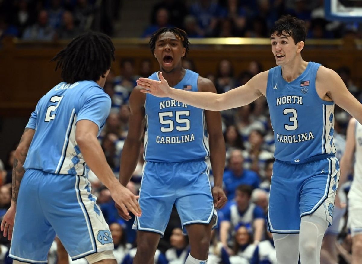 Mar 9, 2024; Durham, North Carolina, USA; North Carolina Tar Heels guard Cormac Ryan (3) and forward Harrison Ingram (55) react to a basket by guard Elliot Cadeau (2) during the second half against the Duke Blue Devils at Cameron Indoor Stadium. The Tar Heels won 84-79.