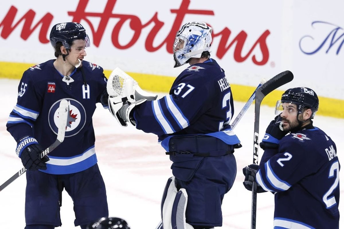 Jan 2, 2024; Winnipeg, Manitoba, CAN; Winnipeg Jets center Mark Scheifele (55) and Winnipeg Jets goaltender Connor Hellebuyck (37) celebrate their victory over the Tampa Bay Lightning at Canada Life Centre.